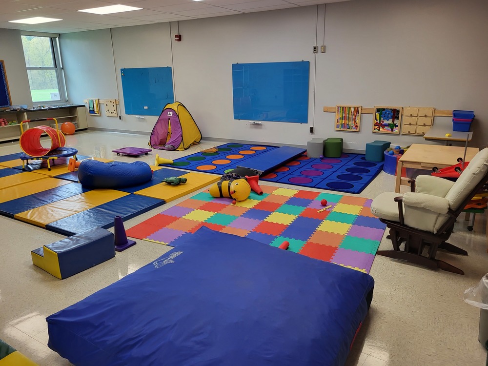 A room with colorful mats and equipment