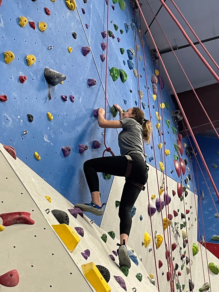 A student climbs a rock wall
