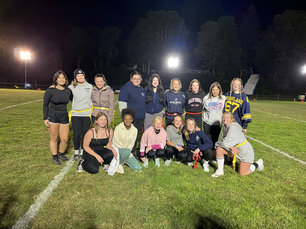 A group of flag football players pose for the camera