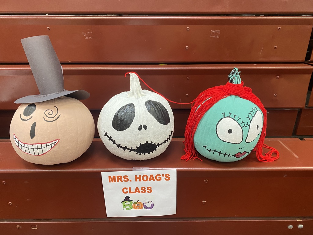 Pumpkins decorated as characters from The Nightmare Before Christmas sit on bleachers above a sign that says Mrs. Hoag's class