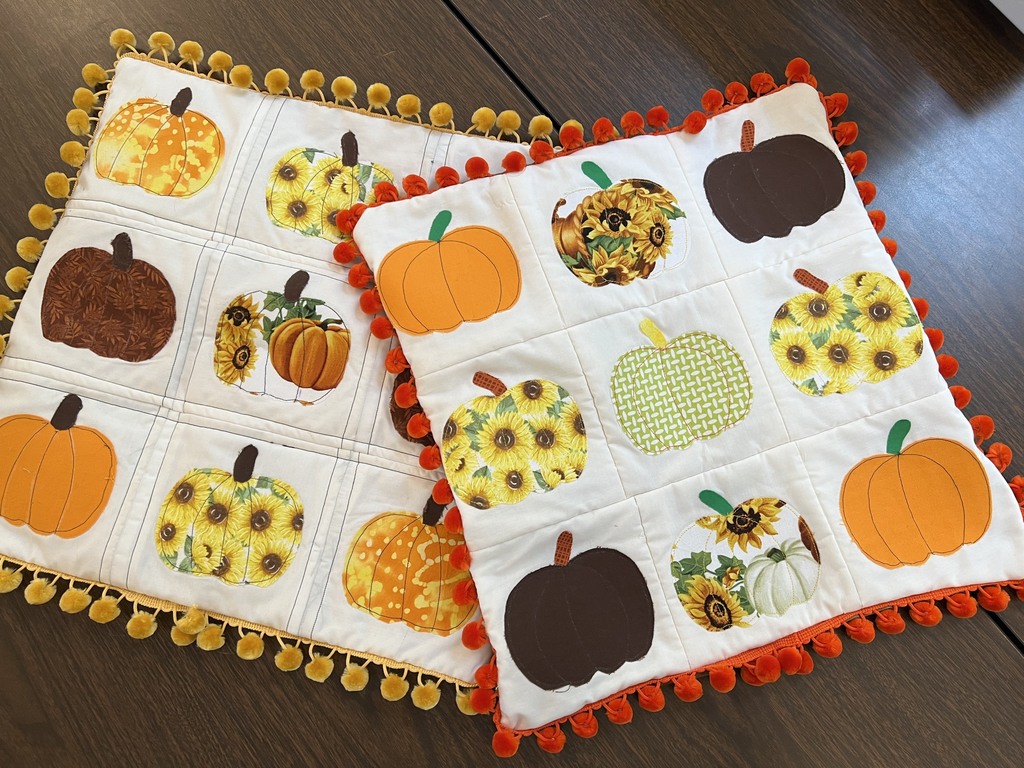 Two sewing projects featuring nine pumpkins on a white background with a red border on one and yellow on the other