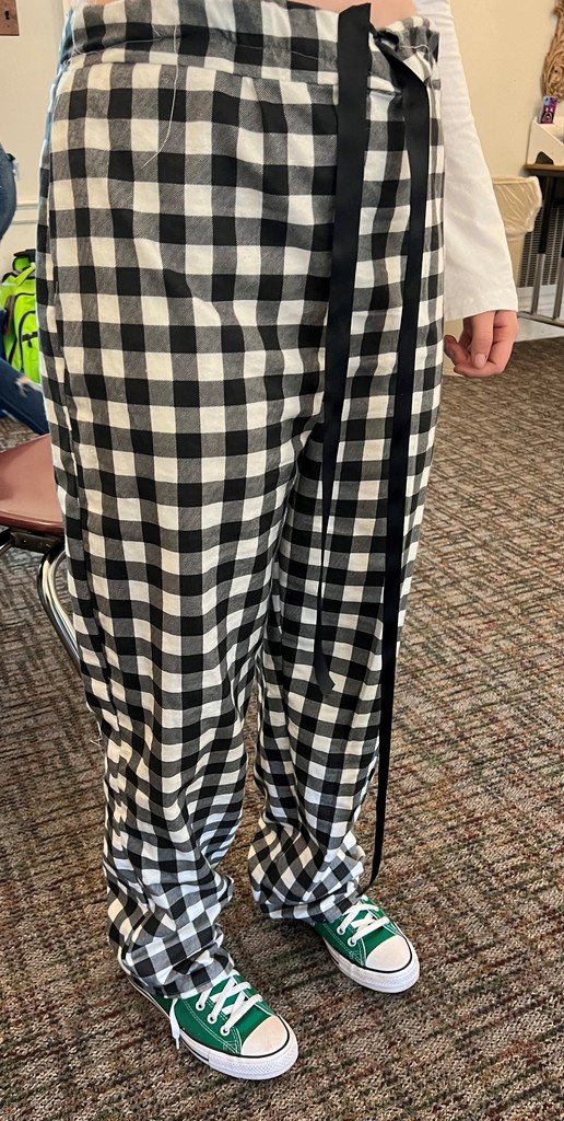 a student modeling black and white checked pj pants