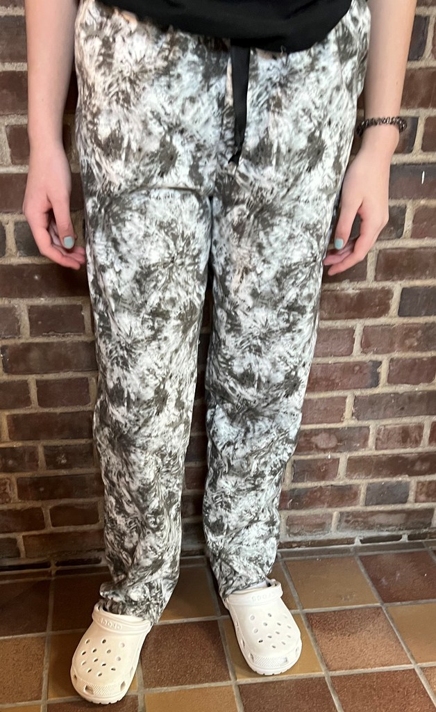 a student models  gray and white patterned pj pants