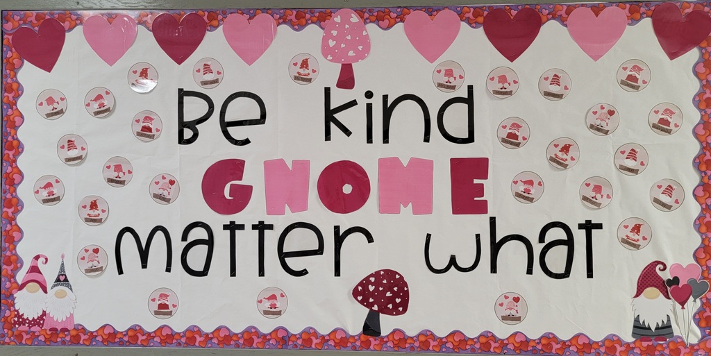 On a white back ground with with a red border, pink and red hearts at the top, gnomes with names on circles, pink and red mushrooms at top and bottom and gnomes in the bottom corners reads "Be Kind, gnome matter what"