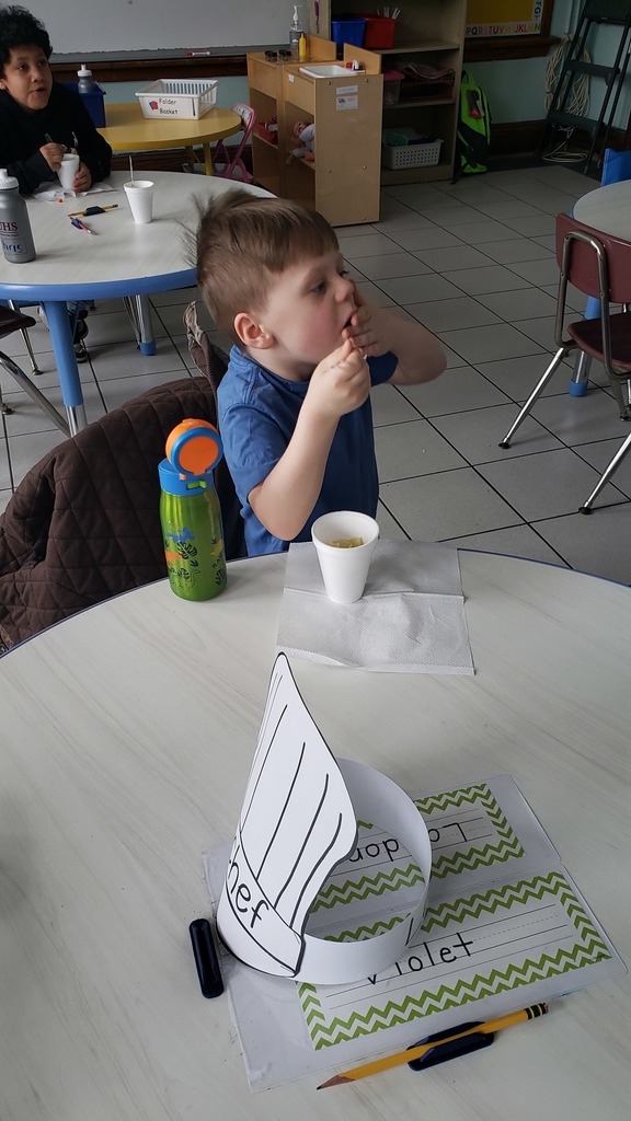 A student sits at a table eating