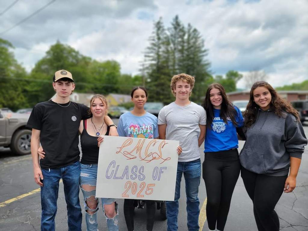 Six students pose for a photo holding a sign that reads LMCS Class of 2025