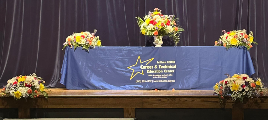A table is set with flowers for the Sullivan BOCES CTE recognition ceremony