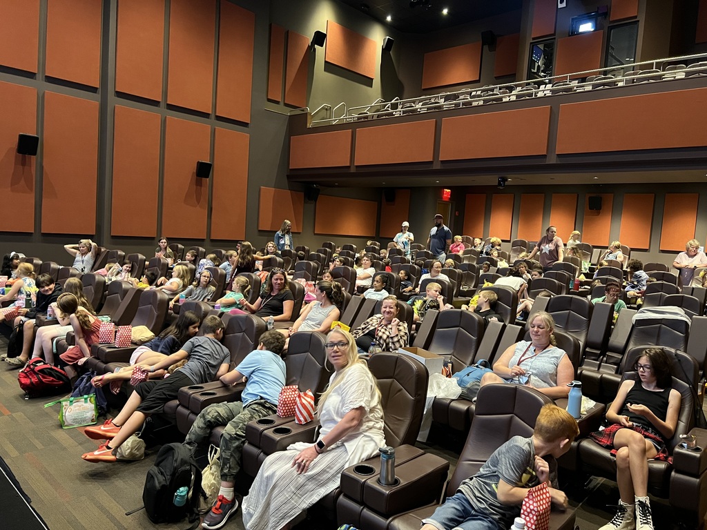 STudents and adults sit in theater seating