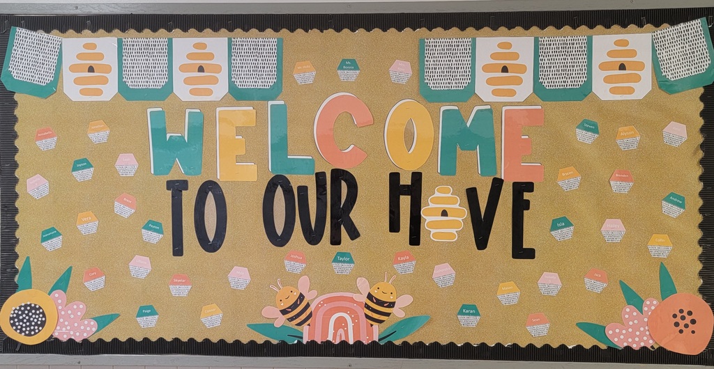 A billboard that reads welcome to our have and is decorated with bees and bee-related items.