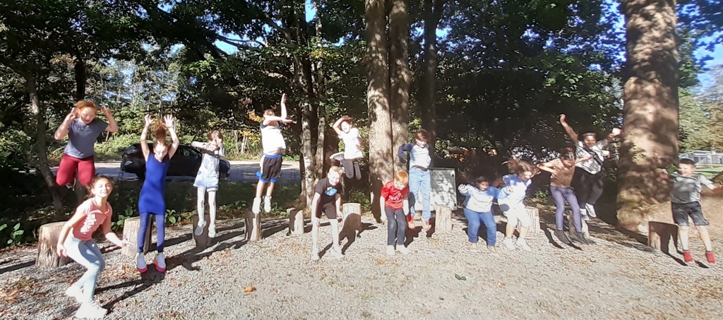 Students jump outdoors for a photo